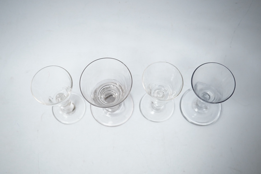 Four late 18th century ale wine and dram glasses, tallest 10.5cm. Condition - largest glass has a fine chip to rim